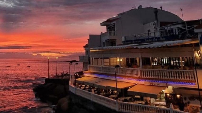 Päikeseloojang Tenerife rannal, restoran ja mererand, kaunis vaade ja rahulik õhkkond.